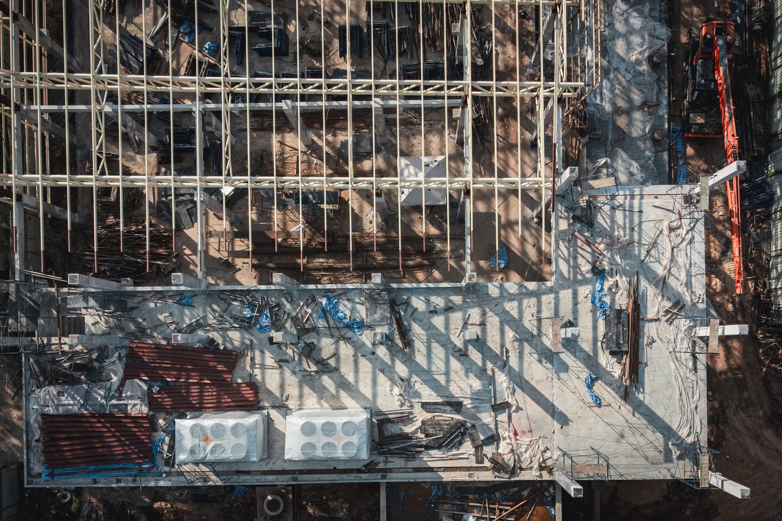 Aerial View Construction Site. Workers Fixing Grid Foundation Bars. Progress and Activity on the Rooftop